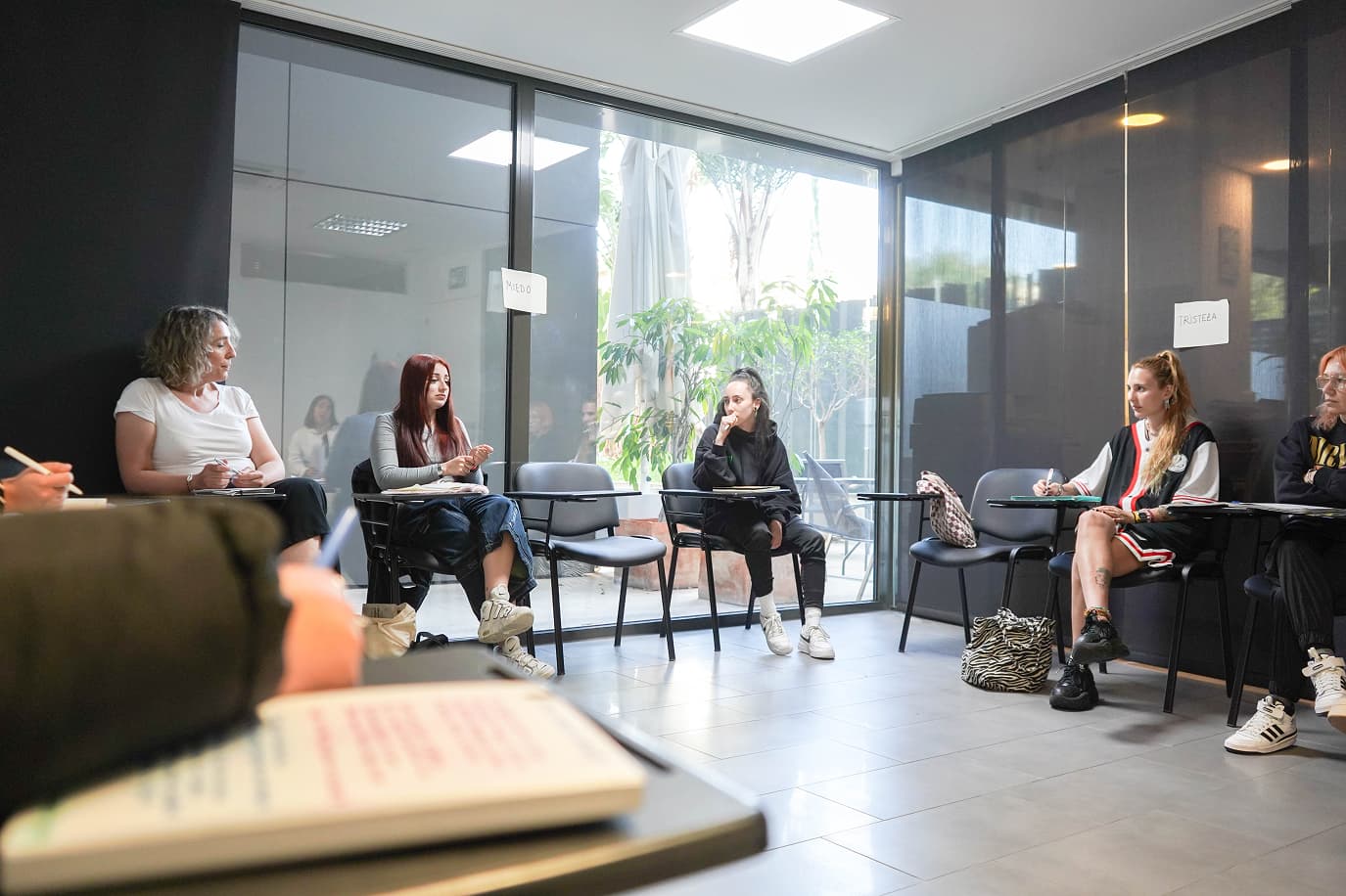 Personas sentadas en ronda en un aula 